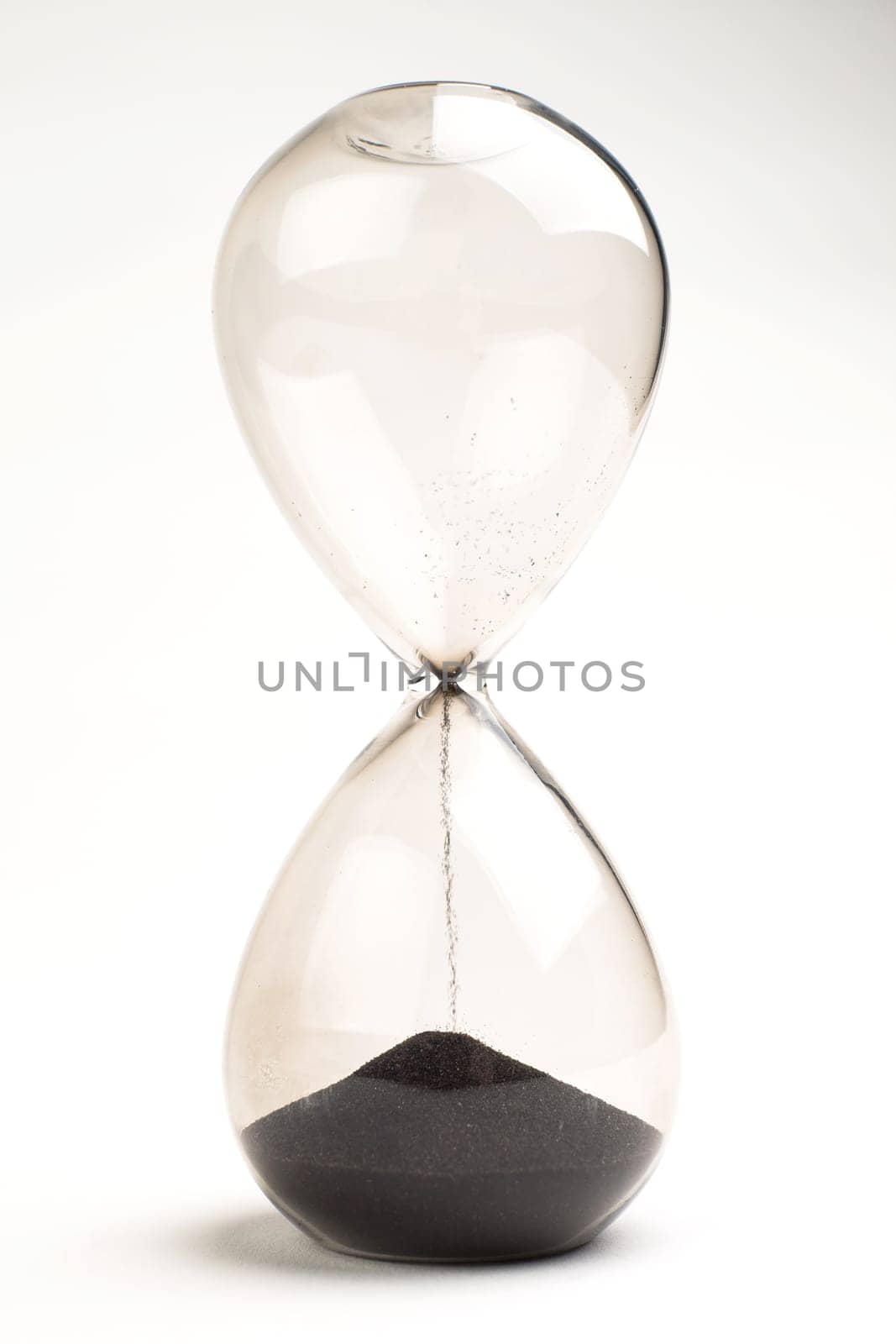 Hourglass as time passing concept for business deadline, urgency and running out of time.