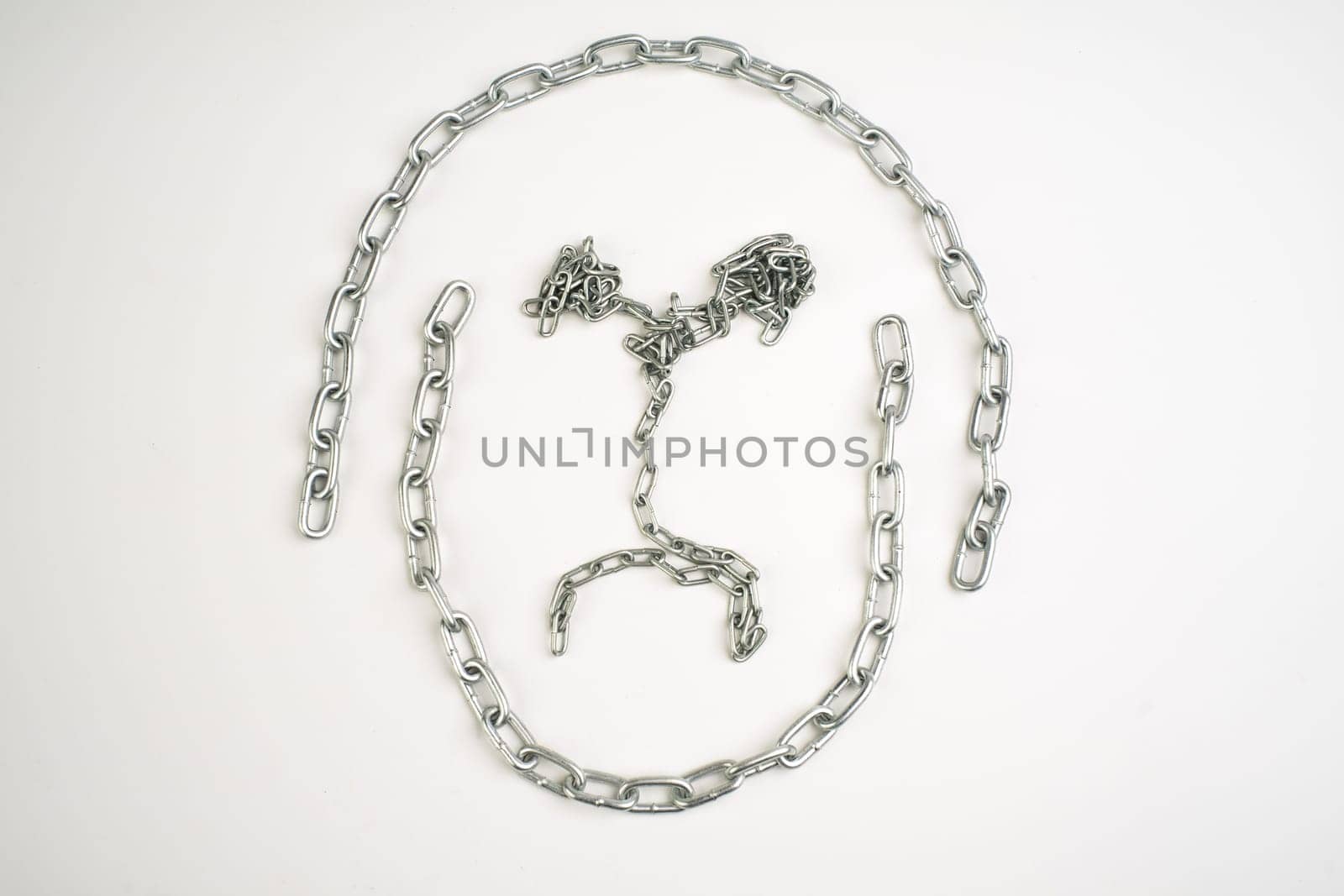 Sad face made of metal chain on a white background.