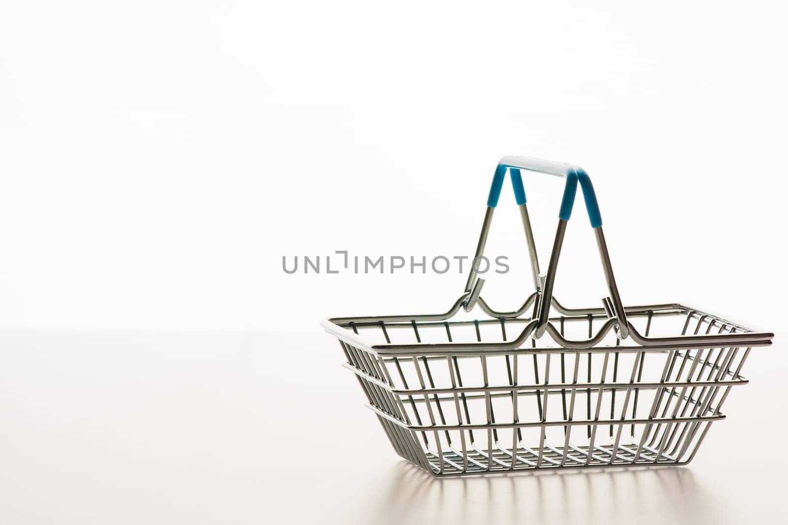 Wire shopping basket isolated on a white background.