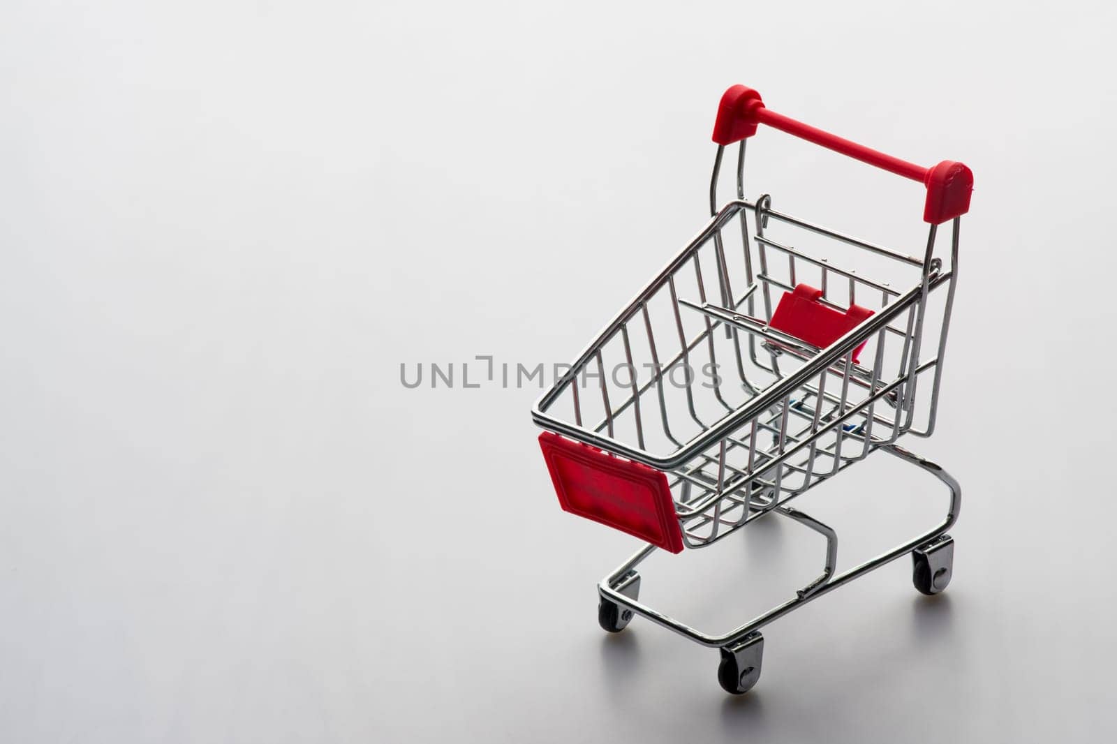 Empty grocery shopping cart. Isolated over white background by zartarn
