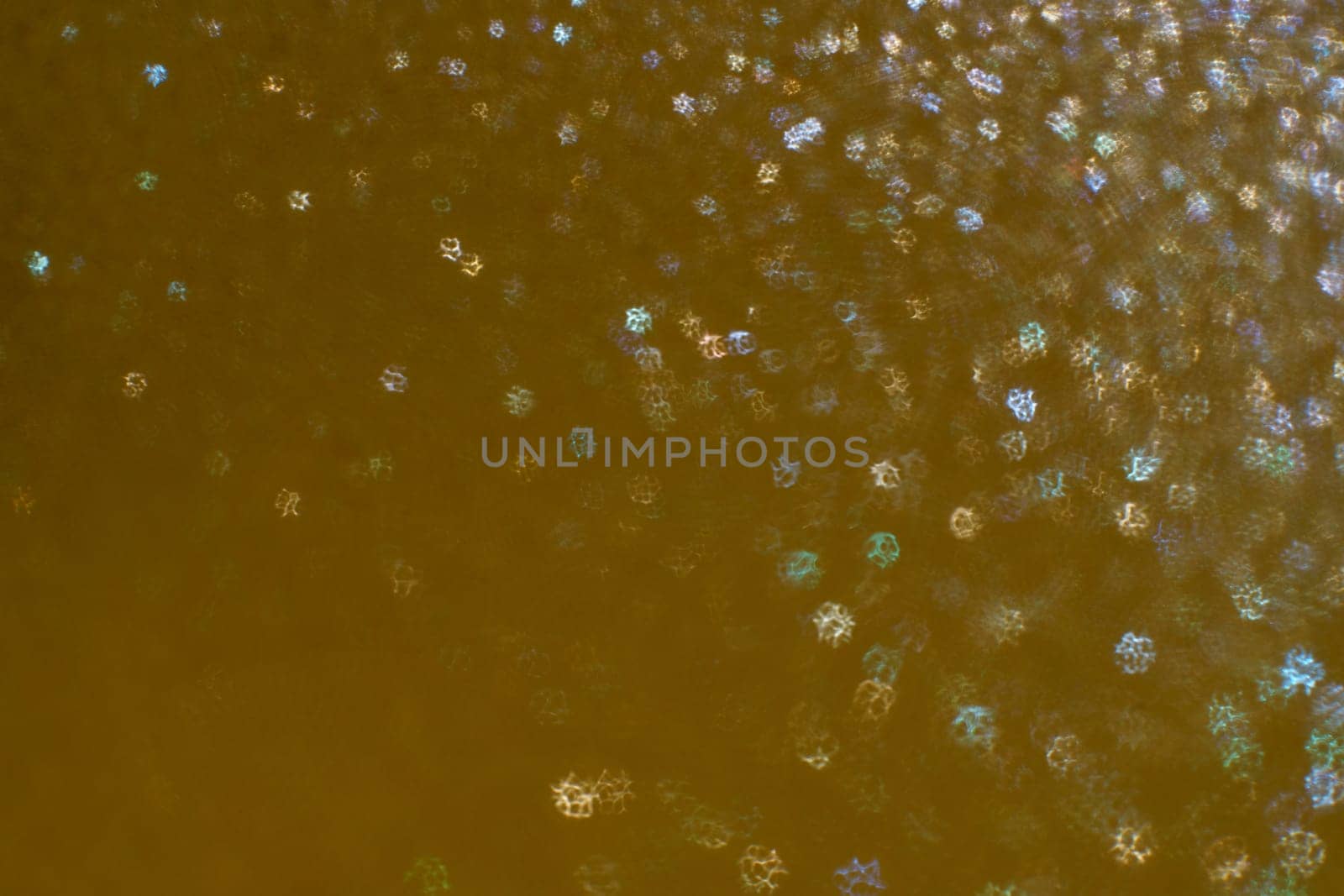 Christmas background. Festive abstract background with bokeh defocused lights and stars.