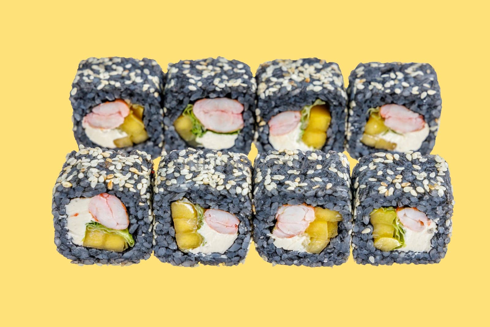 rolls with black rice, shrimp and avocado on a yellow background 1