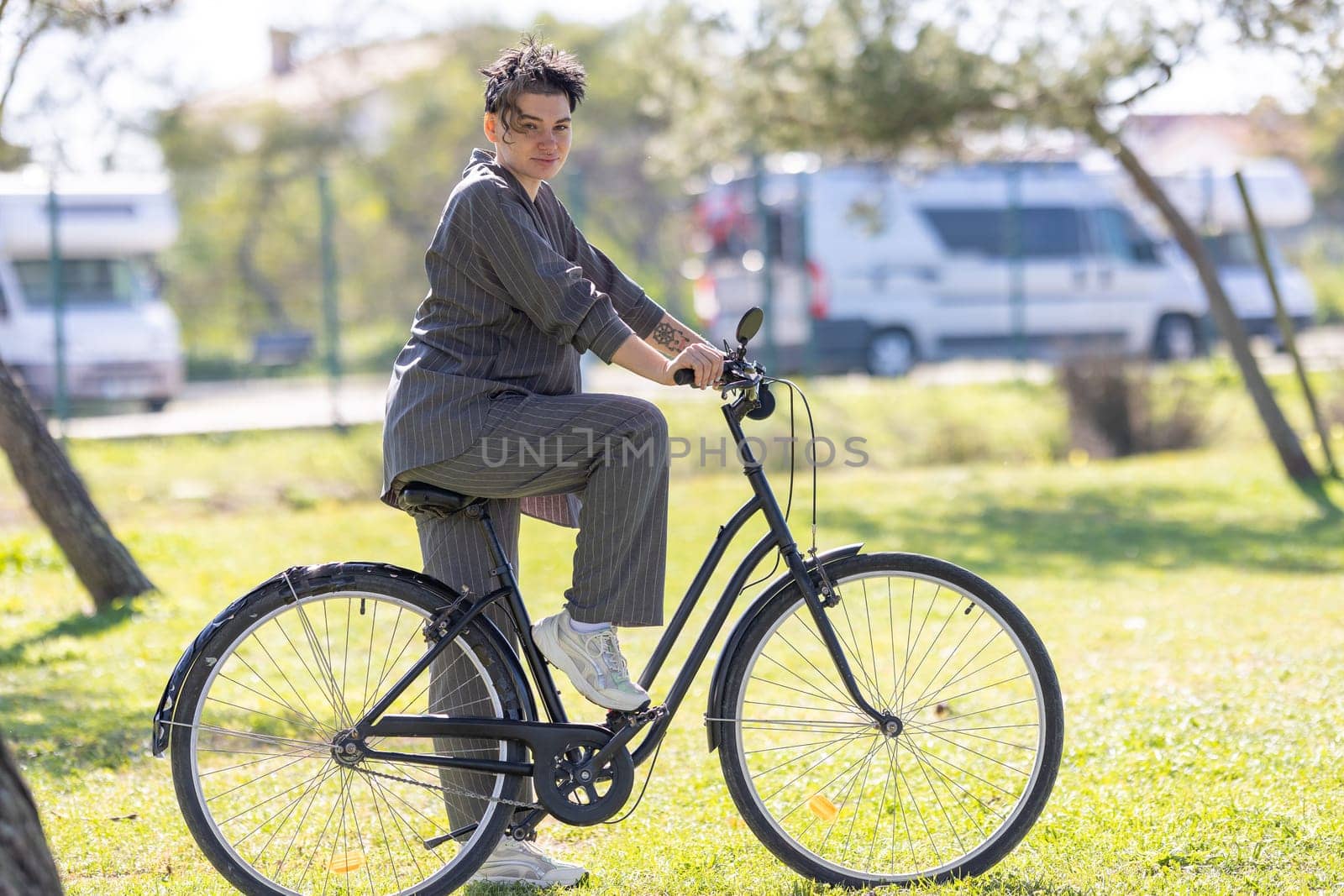 A woman is riding a bicycle in a park by Studia72