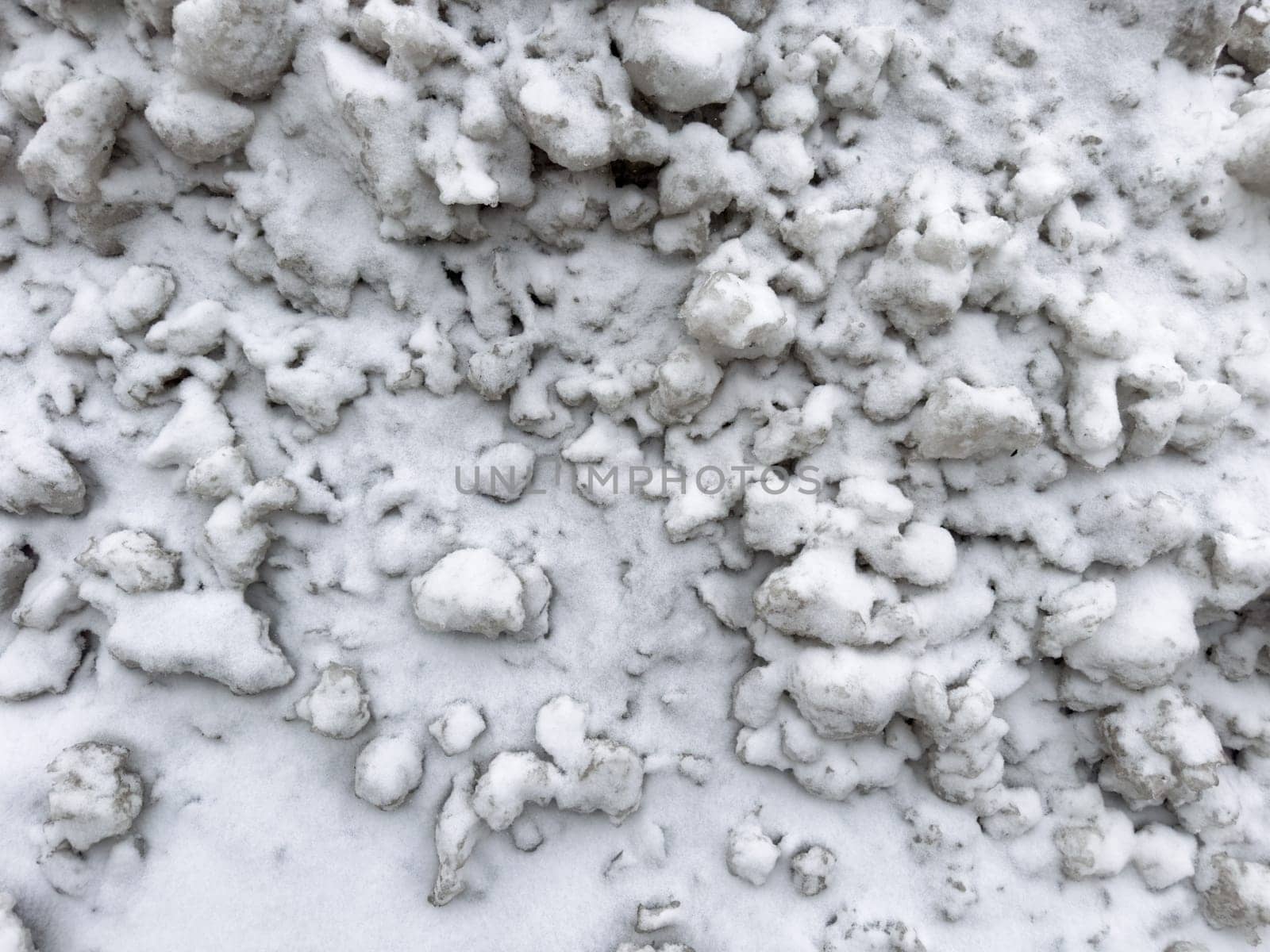 texture pieces of white snow lie on the road