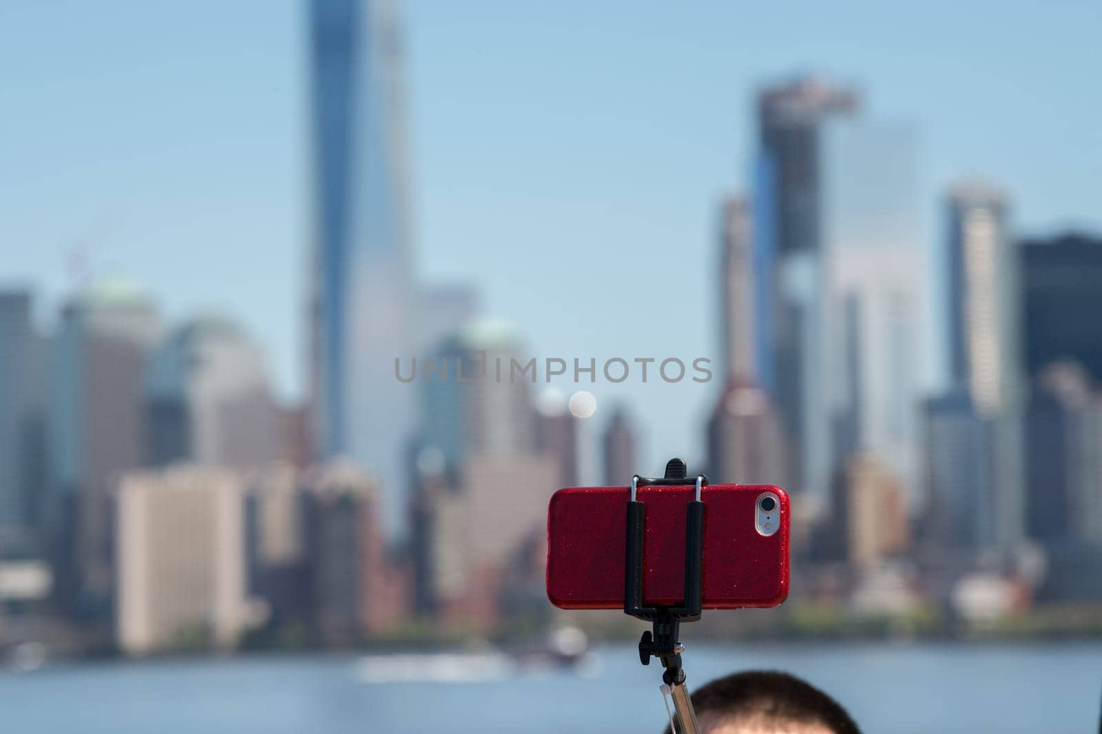 new york manhattan statue of liberty tourist selfie with smartphone by AndreaIzzotti