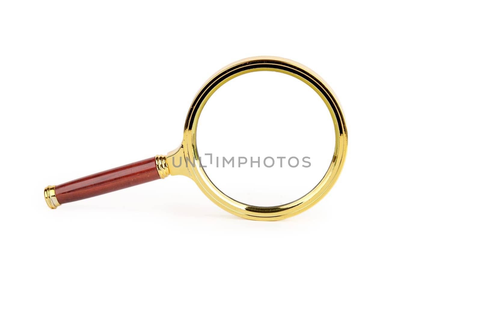 A magnifying glass with a beautiful handle stands on the end on a white background