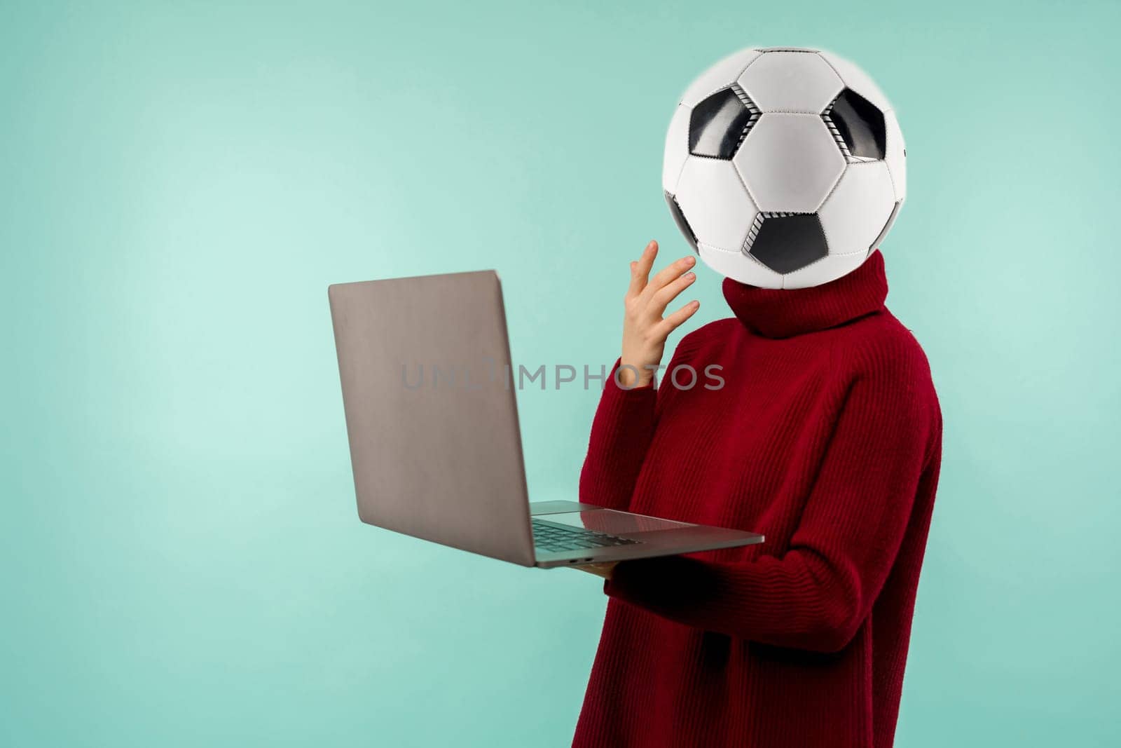 Abstract modern collage. woman soccer ball instead of a head in sweater looking laptop computer screen over blue background by zartarn