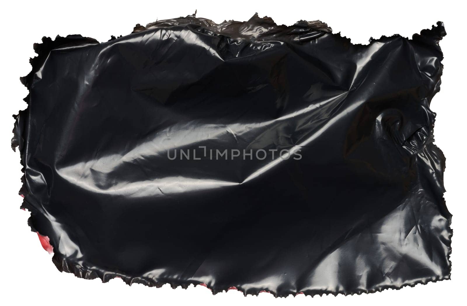 Torn piece of black polyethylene on isolated background by ndanko