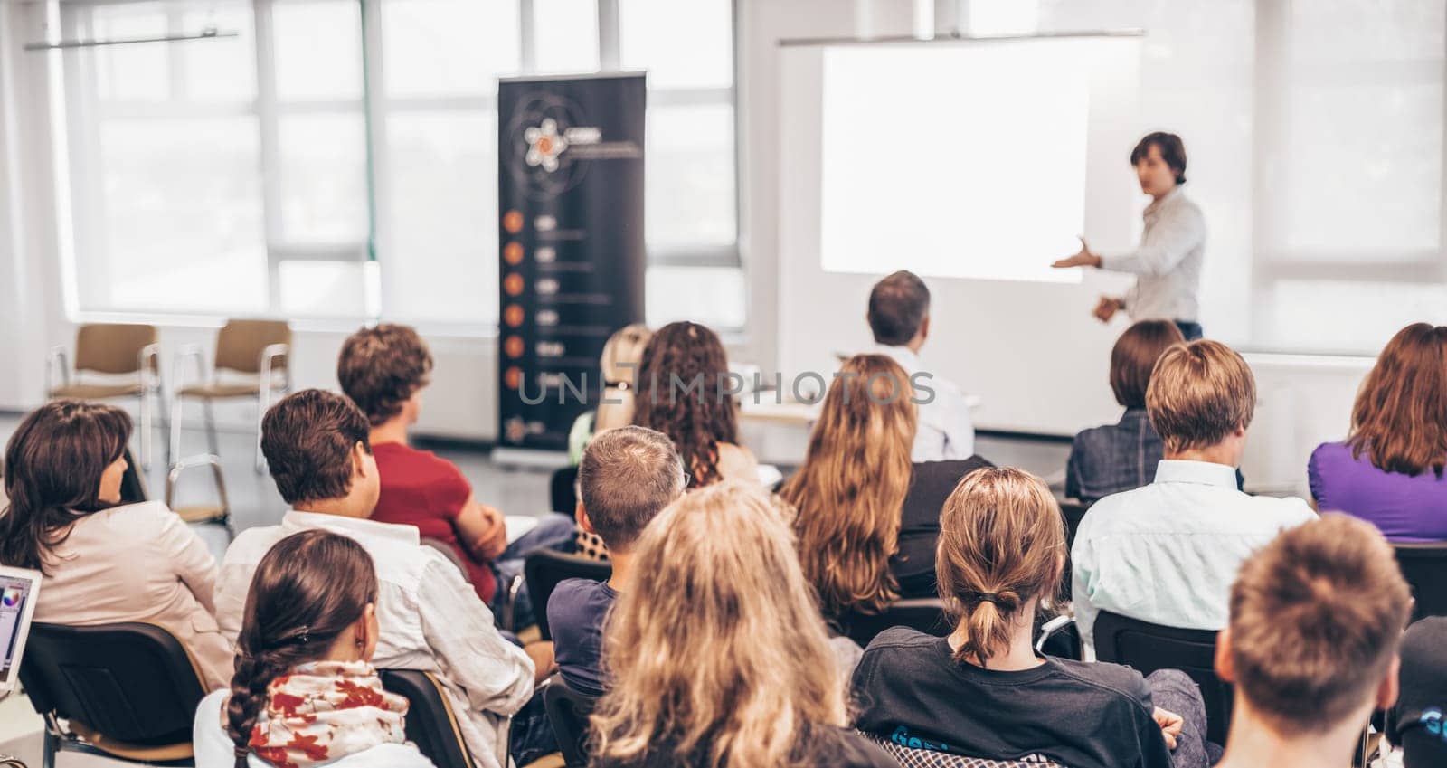 Woman giving presentation on business conference. by kasto