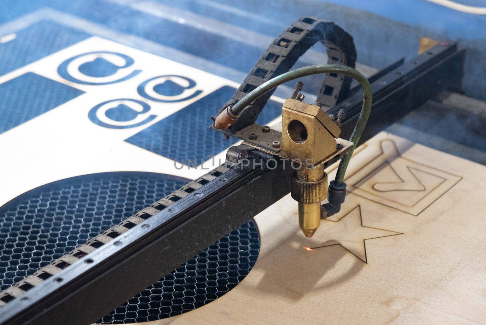 Laser cuts star from plywood. Laser. Plywood. Production.