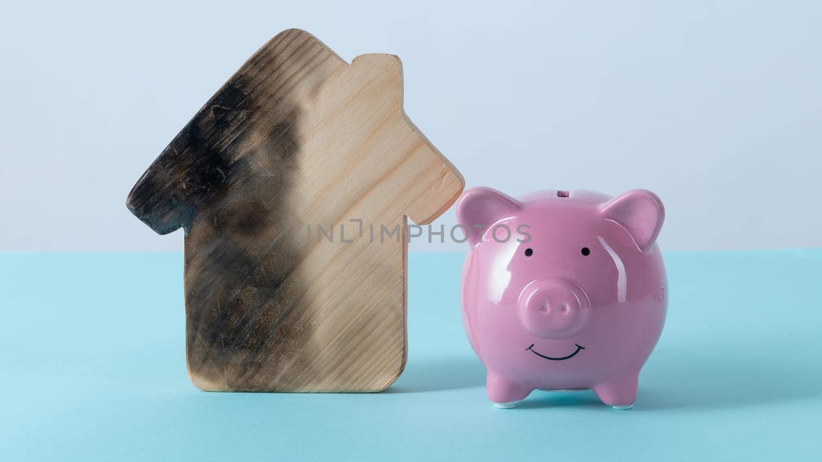 burn house and Piggy bank. Fire insurance concept