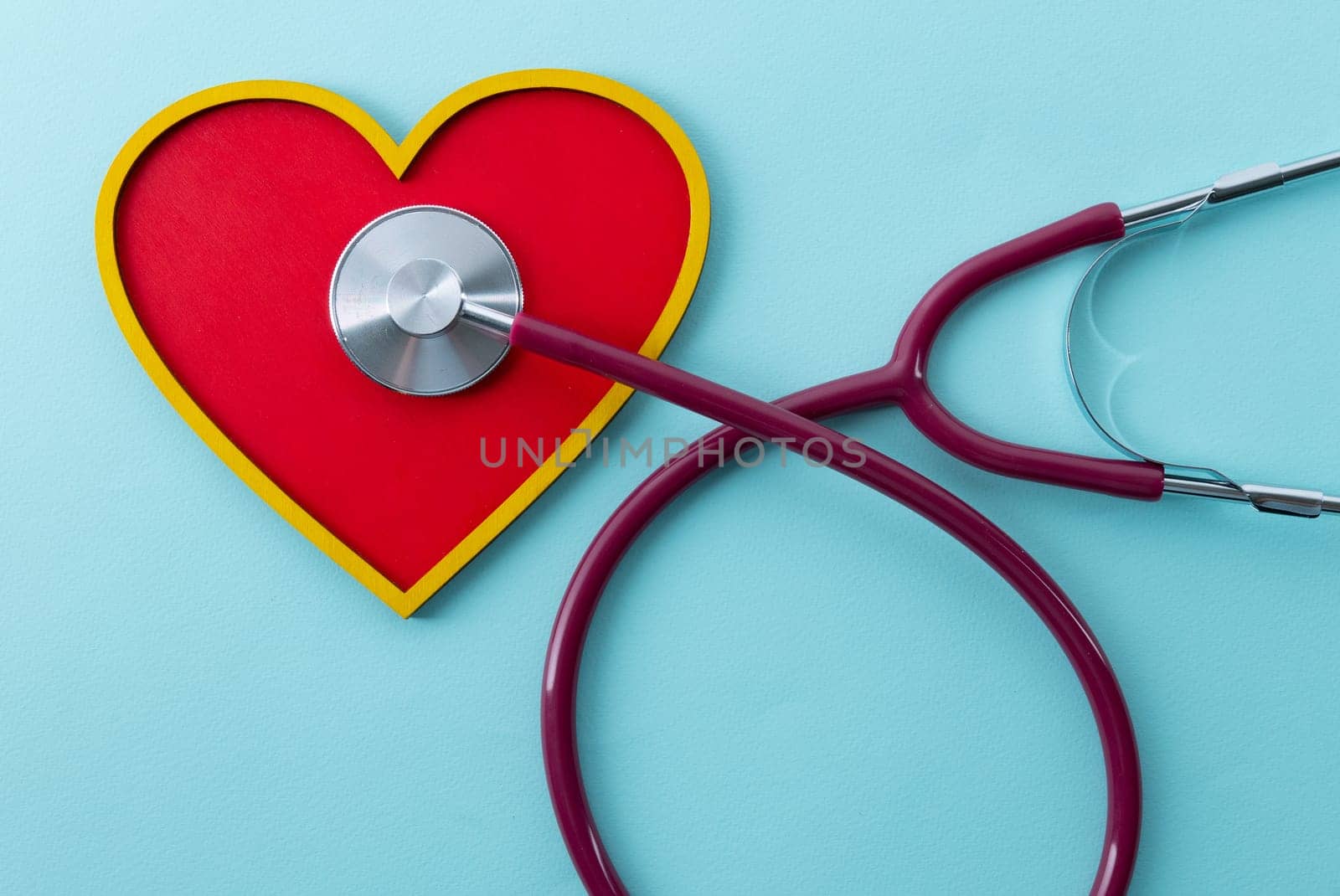 Red heart and stethoscope lies on a blue background by zartarn
