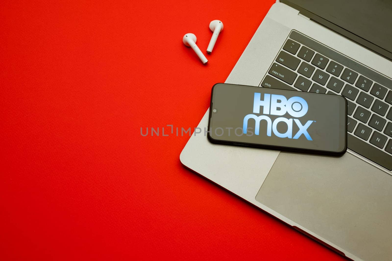 Tula, Russia - Jan 10, 2022: HBO Max logo on smartphone screen on red background. by zartarn