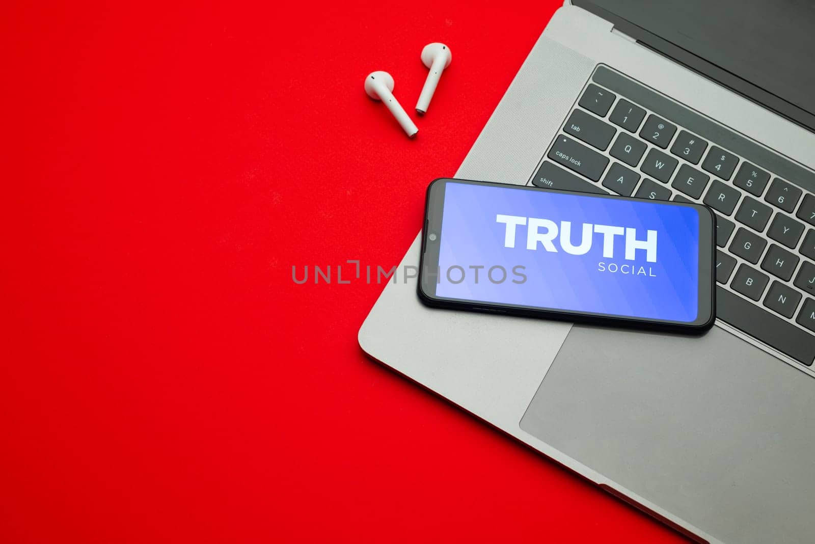 Tula, Russia - Jan 10, 2022: Truth Social app logo on smartphone screen on red background. New social media platform from Donald Trump.