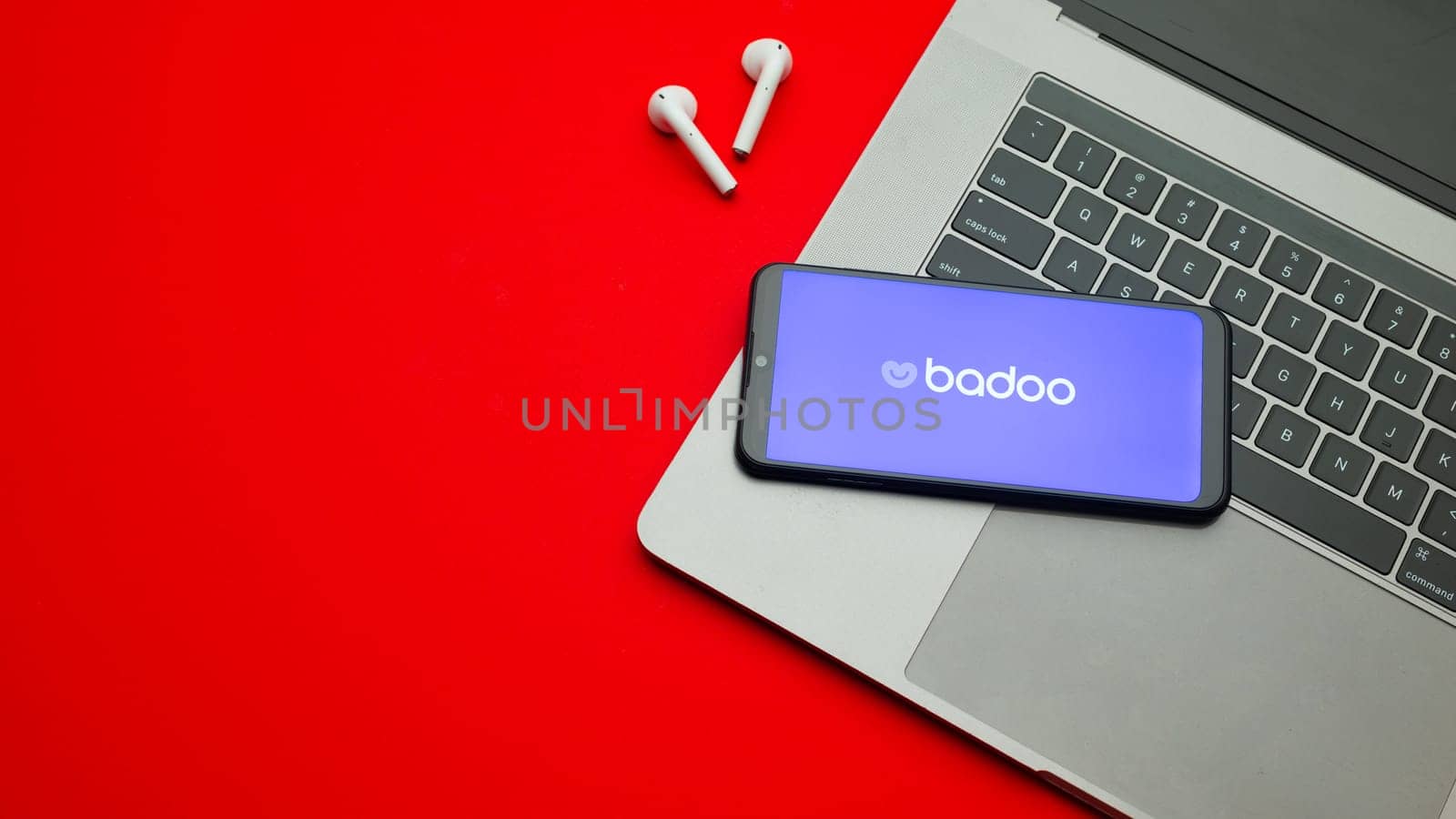 Tula, Russia - Jan 10, 2022: Badoo logo on smartphone screen on red background.