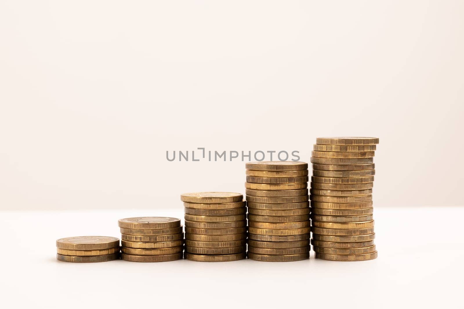 coins stacked on a white background. Money saving concept by zartarn