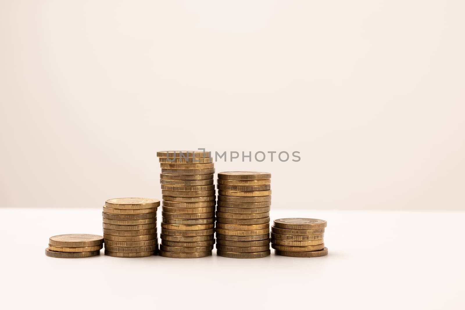 coins stacked on a white background. Money saving concept