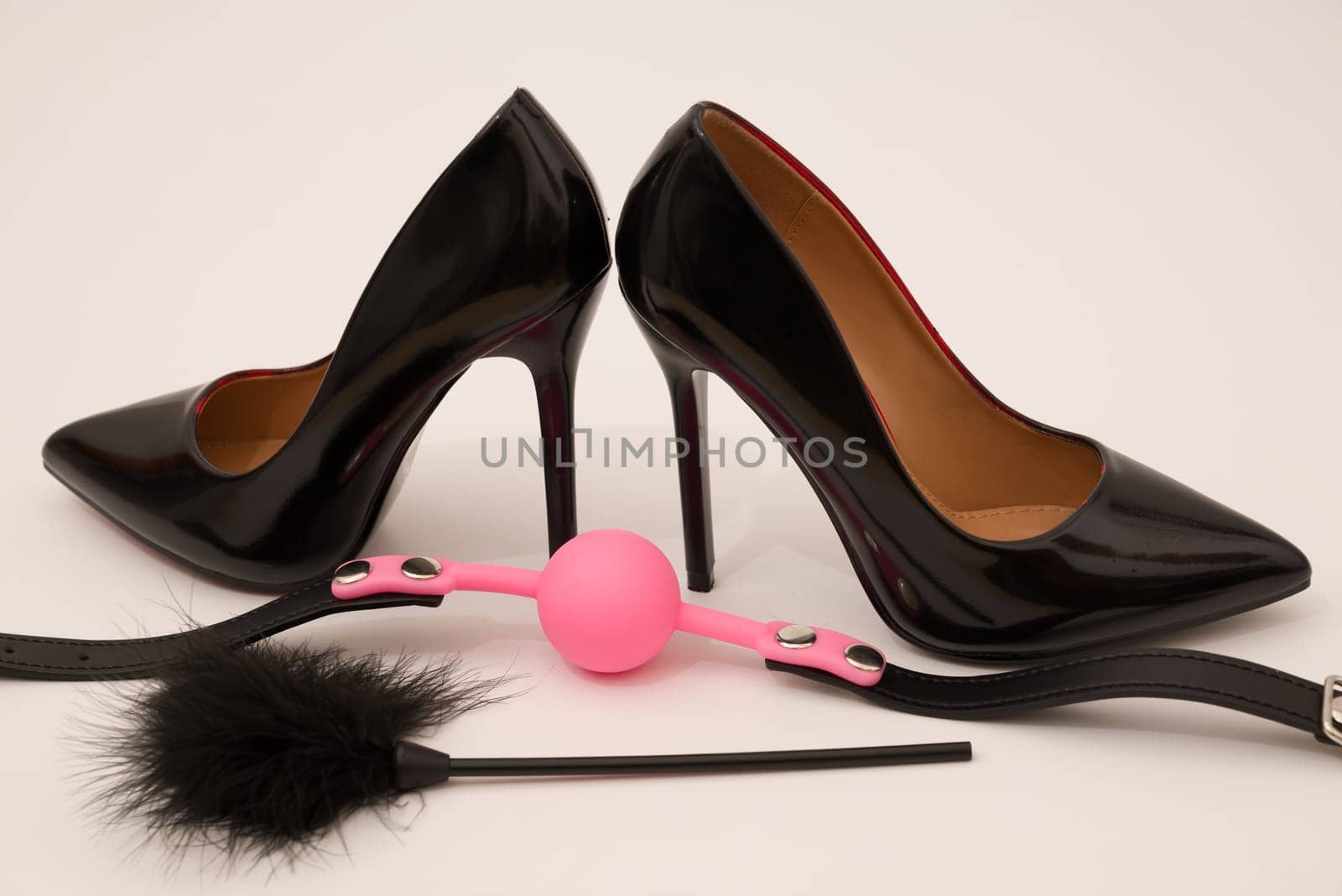 high heel fetish shoes feathered and ball gag fetish equipment isolated by zartarn