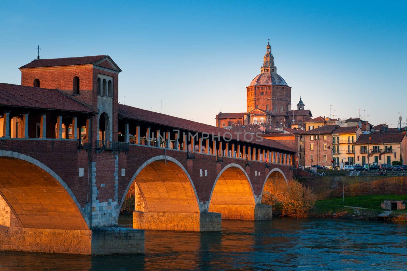 Panorama of covered bridge and Pavia cathedral at sunset by Robertobinetti70