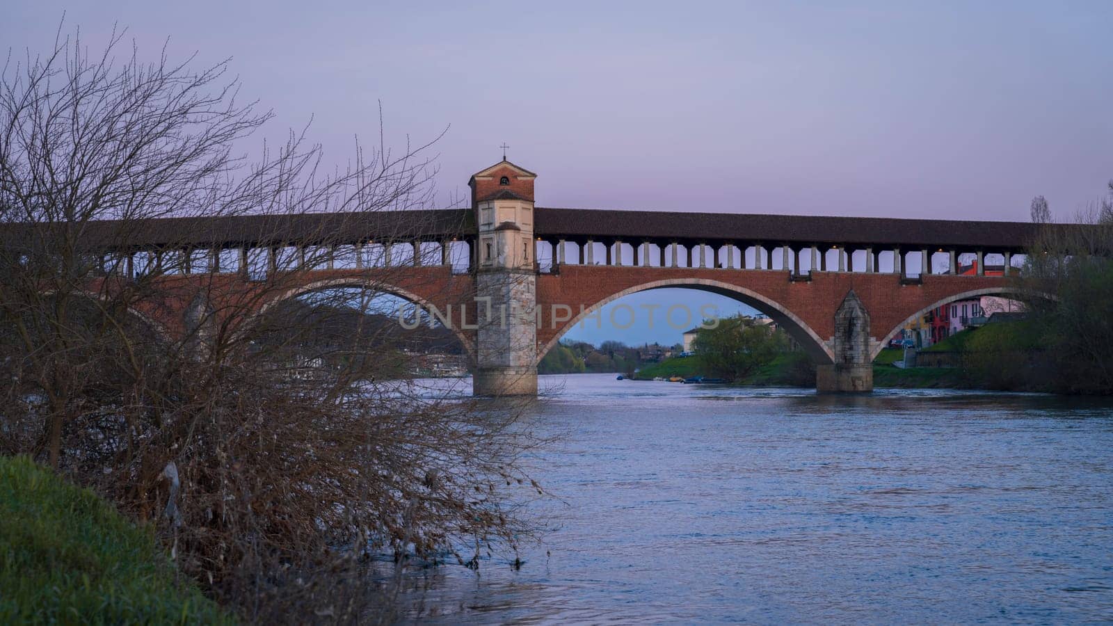 Wonderful view of Ponte Coperto (covered bridge) is a bridge over the Ticino river in Pavia at blue hour, Lombardy, Pavia, Italy