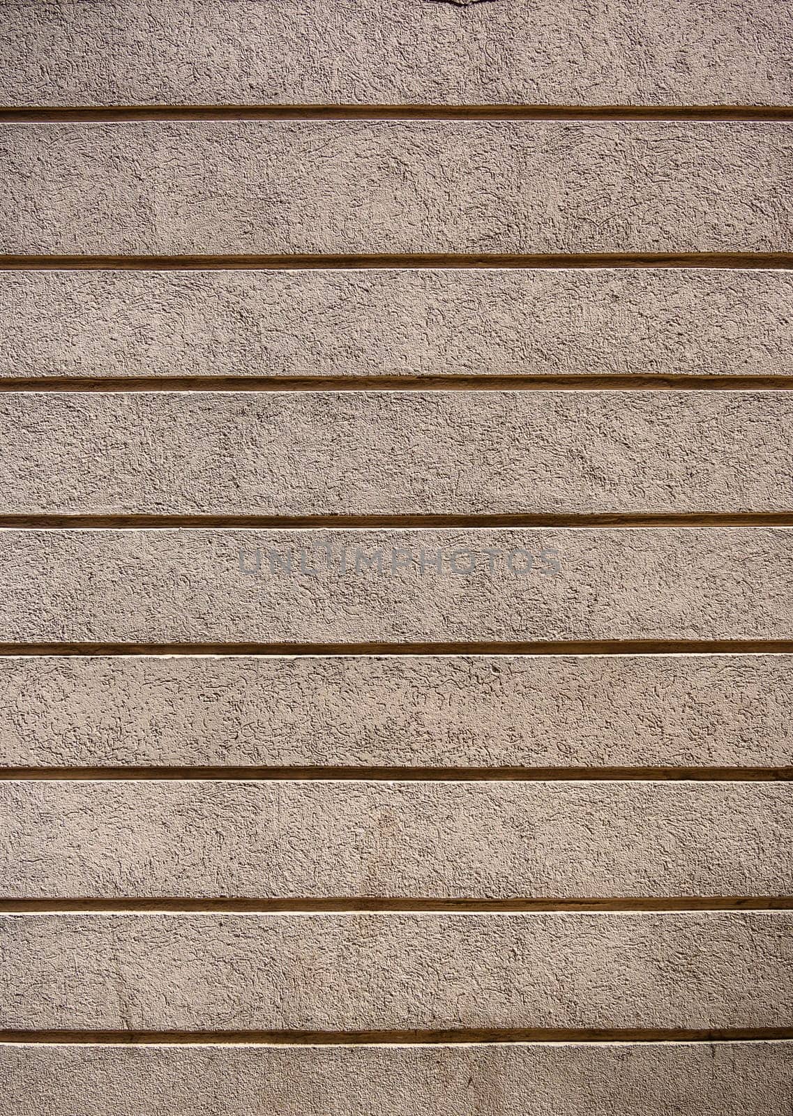 Beautiful exterior wall of a renovated house painted with a soft light color, enriched with a geometric horizontal striped texture. This design adds a contemporary and elegant touch by Mixa74