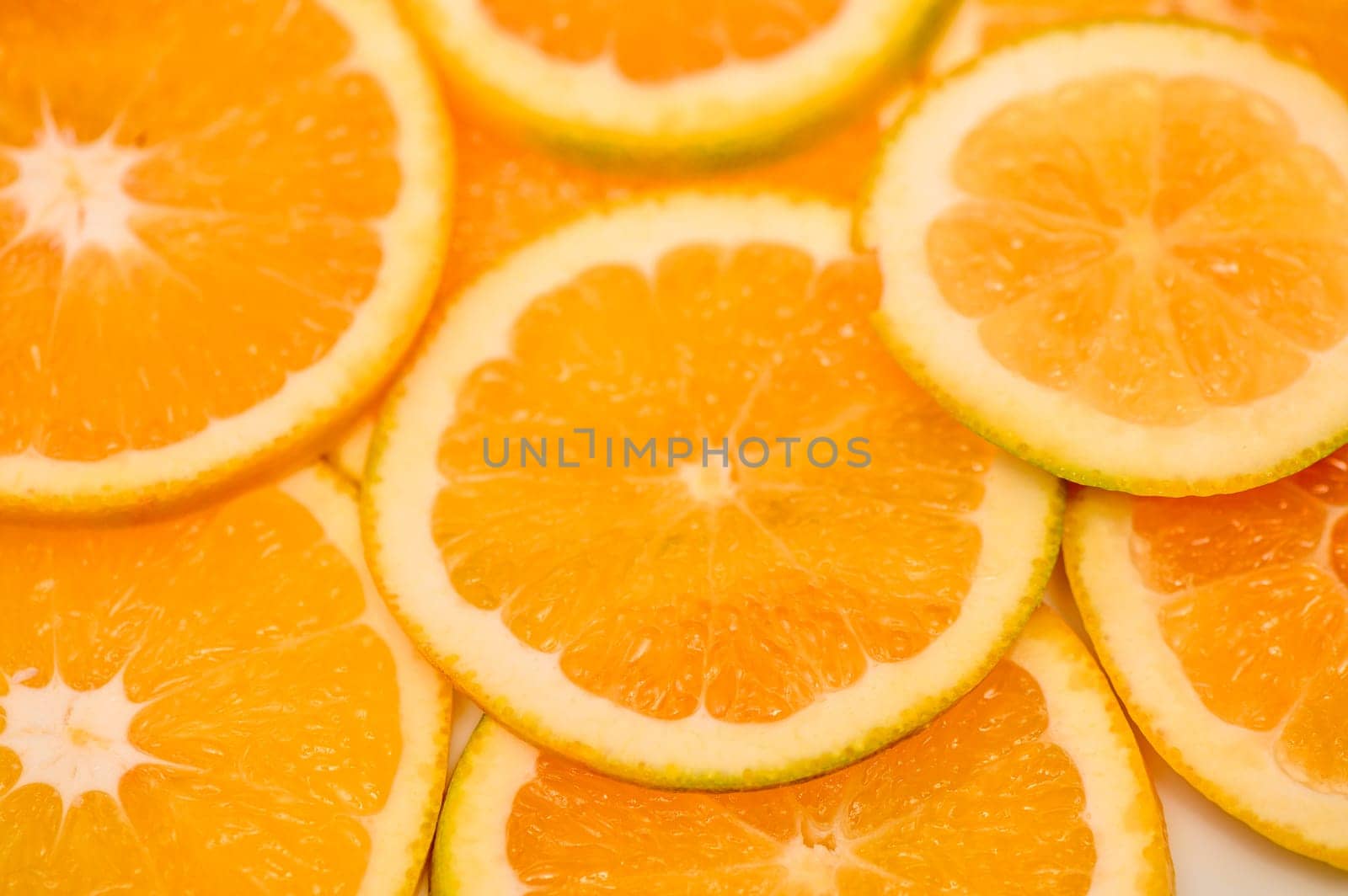 Closeup of sliced juicy oranges textured background 1