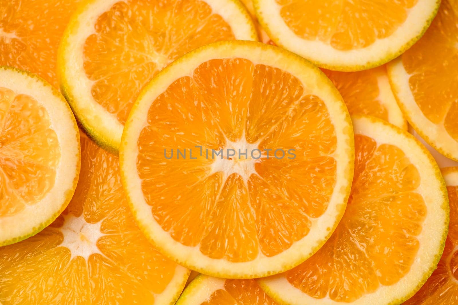 Closeup of sliced juicy oranges textured background by Mixa74