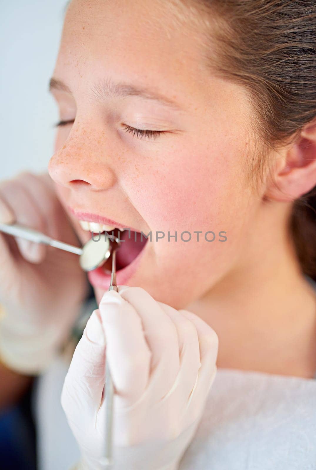 Dental, exam and girl and dentist with mirror zoom for tooth cavity or gum disease search. Oral care, tool or kid consulting specialist for teeth whitening, growth or bacteria, braces or development.