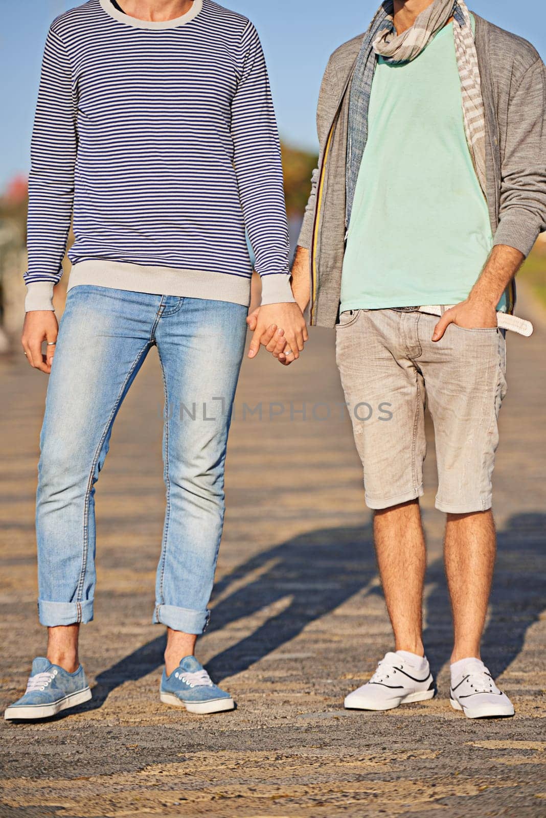 Holding hands, couple and clothes for fashion on road, location and city of Cape Town for love. Gay, person and partner with pride for relationship on date, sunshine and summer to relax and aesthetic.