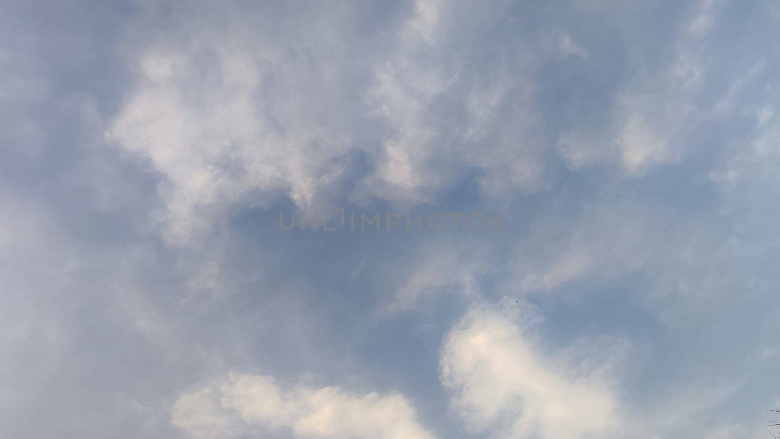 Blue gray light sky nature white clouds whether background, sun face . High quality photo