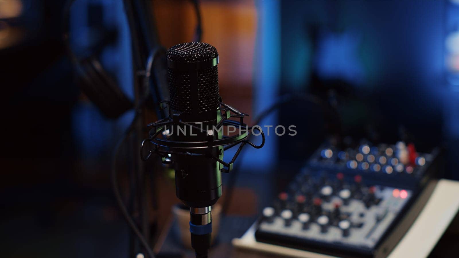 Close up shot of professional microphone used to record podcast conversations by DCStudio