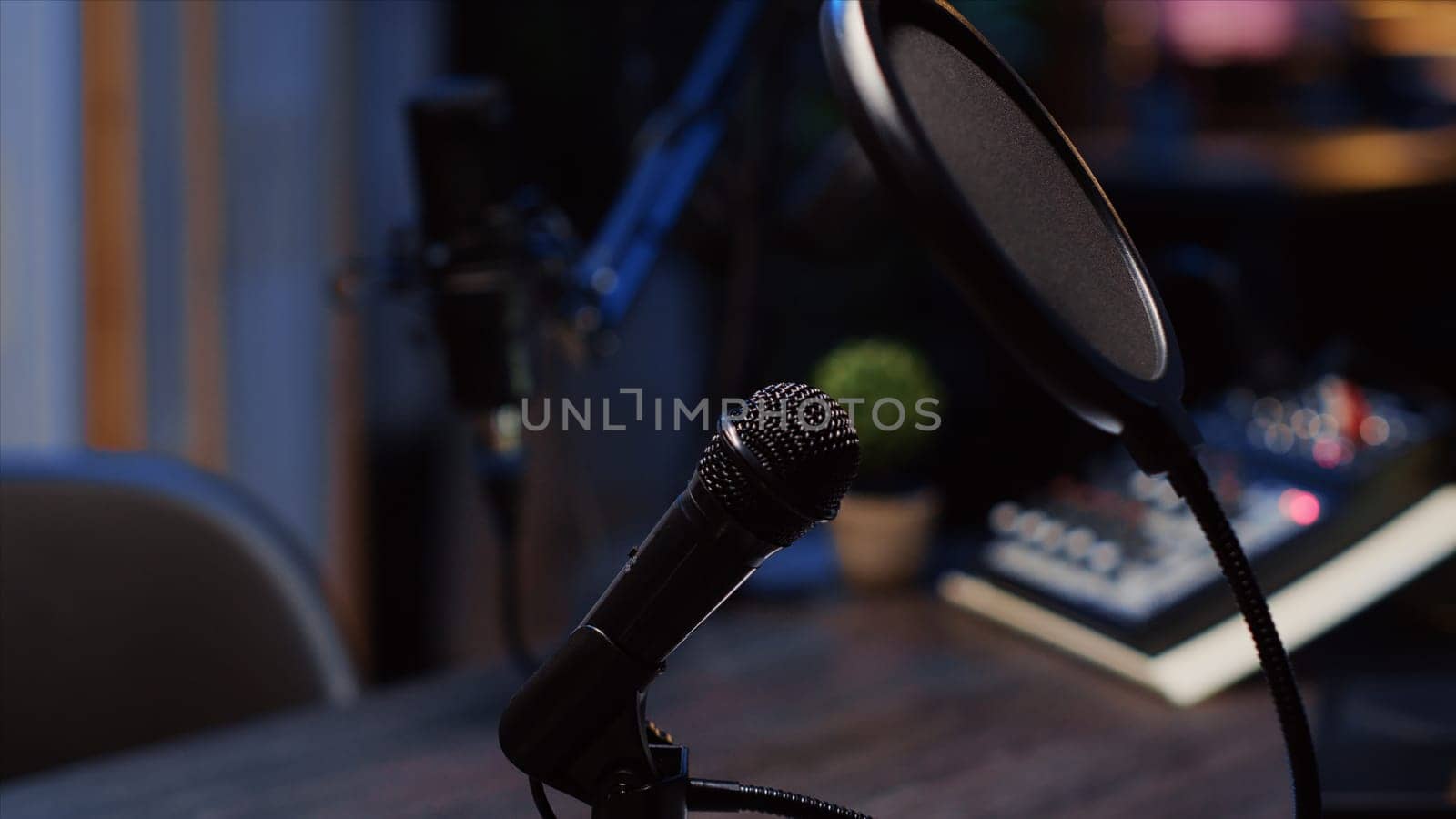 Zoom out shot of podcast microphone used to record conversations with impeccable sound quality for internet show. Close up shot of audio capturing and recording technology