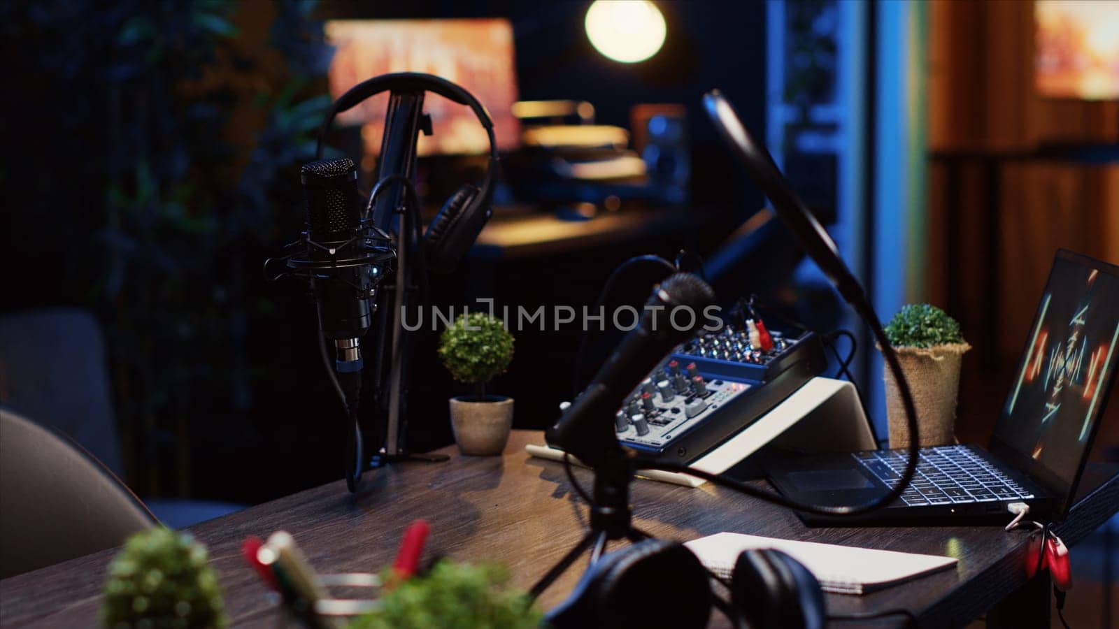Panning shot of desk in home production studio with podcast equipment technology recording by DCStudio