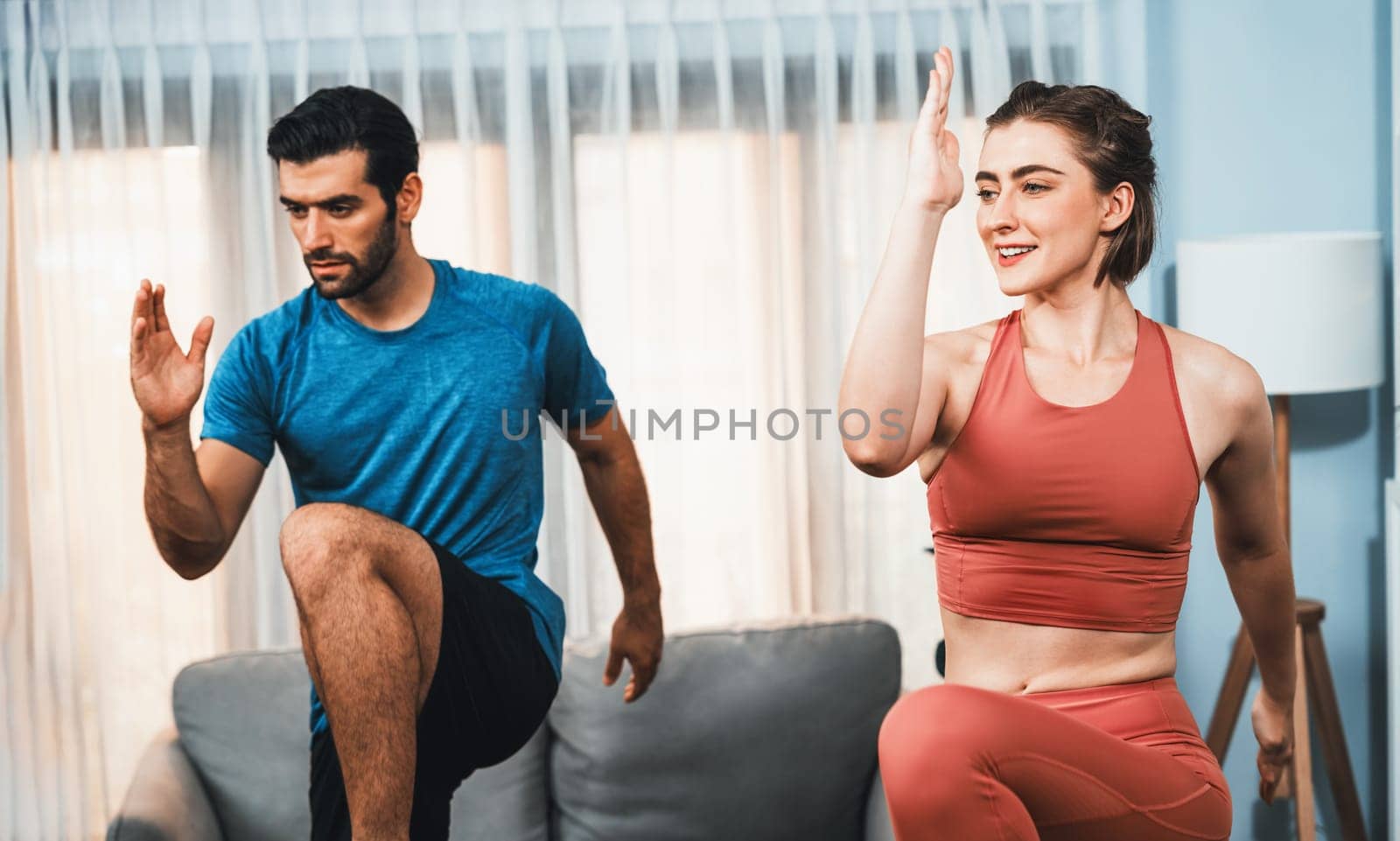 Athletic and sporty fitness couple or exercise buddy running posture at home body workout exercise session for fit physique and healthy sport lifestyle at home. Gaiety home exercise workout training.