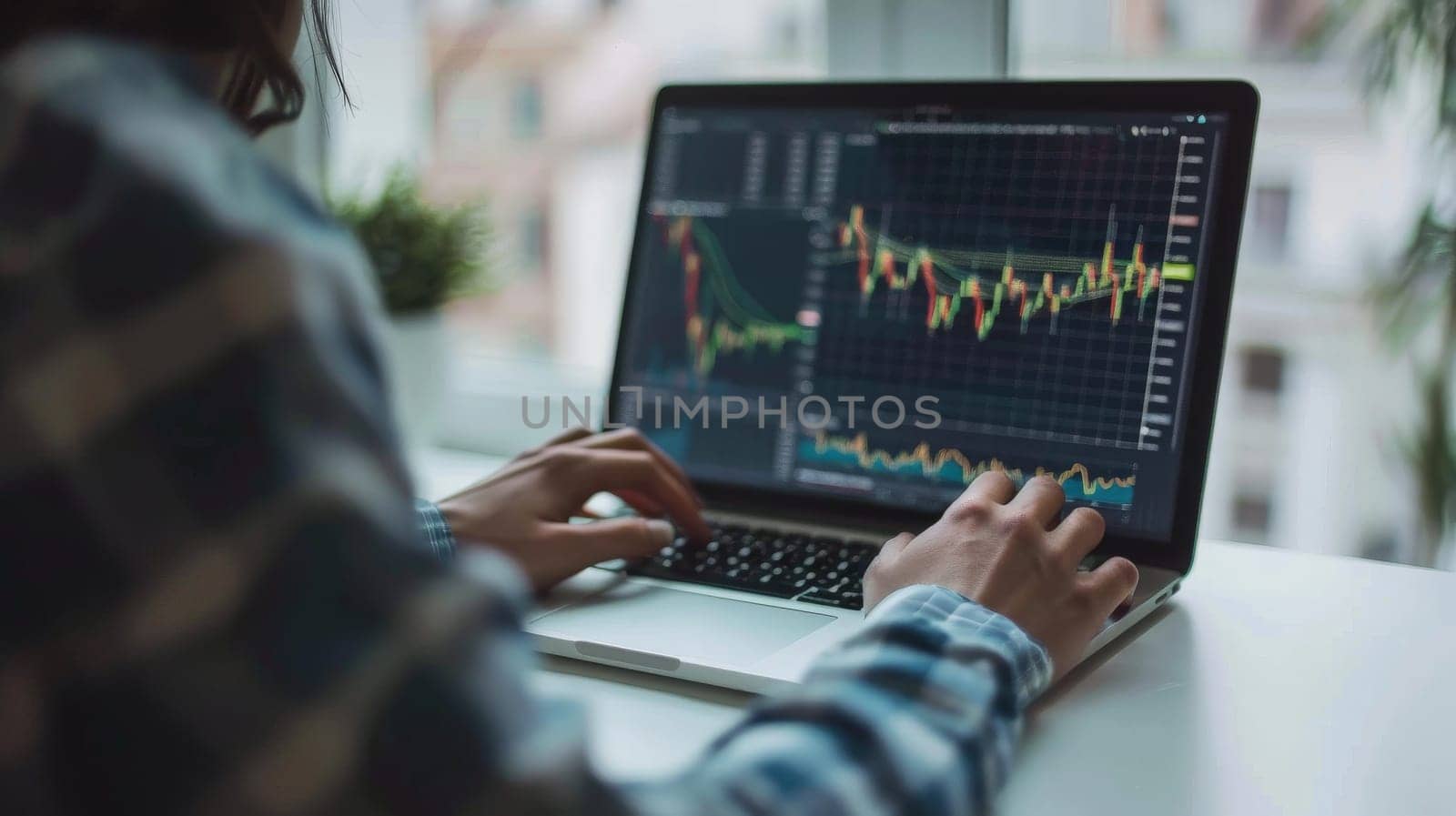 A close up photo of a young investor studying stock options on a laptop.