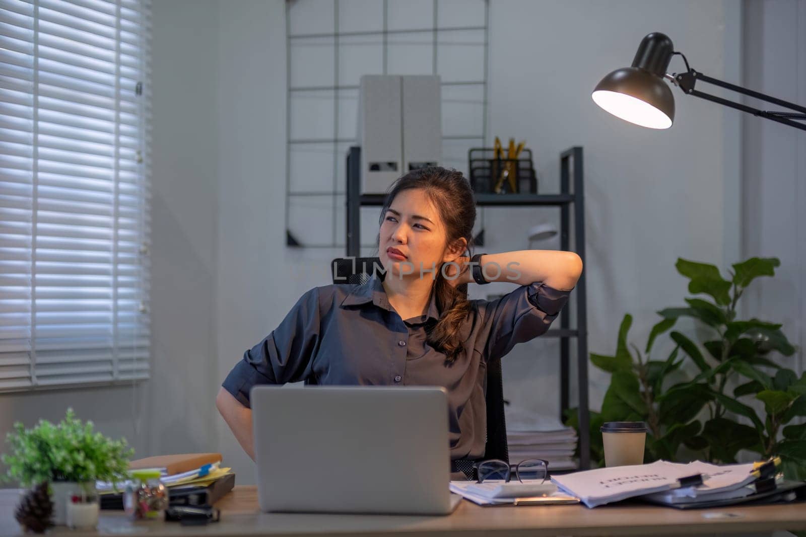 Young businesswoman who is tired from sitting for a long time in the office.