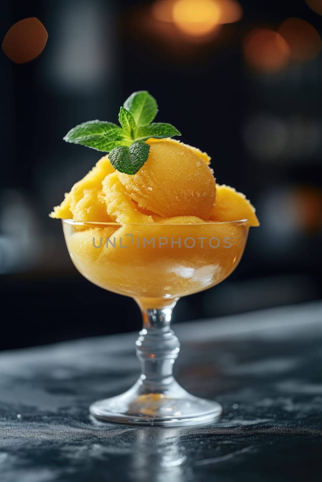 Mango sorbet in a glass on the table . Popsicle in a glass.