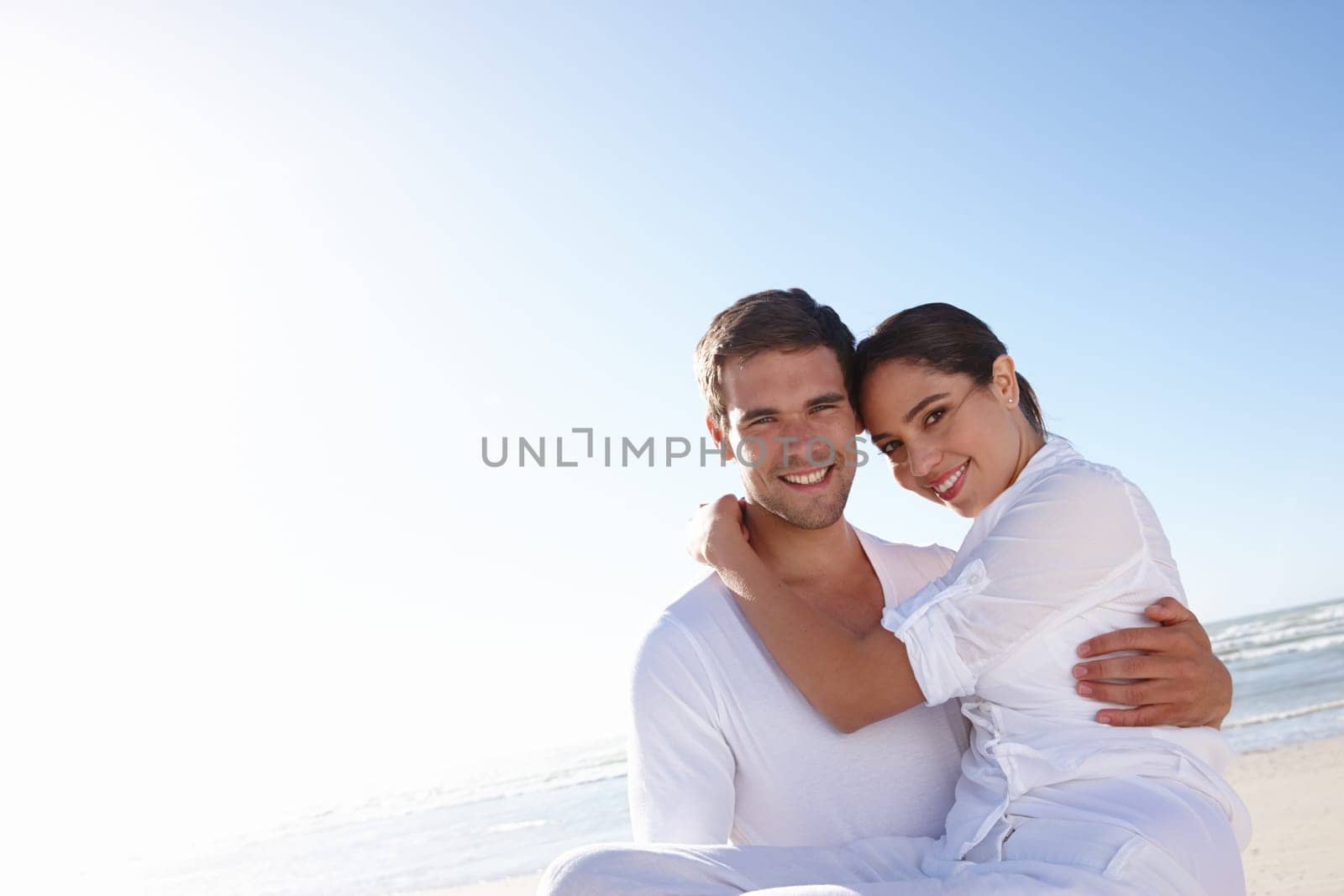 Smile, beach and portrait of couple with embrace for love, summer vacation and bonding on holiday. Man, woman and ocean with happiness for anniversary, romance and tourist adventure in California by YuriArcurs