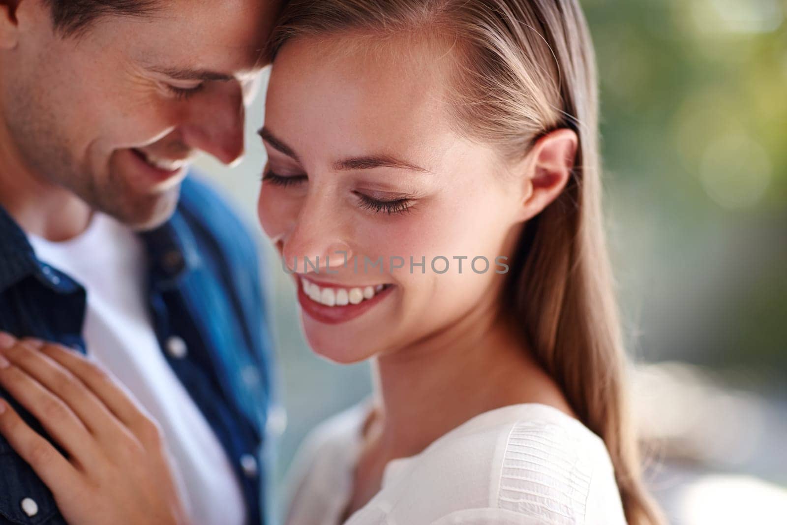 Touch, couple and forehead in embrace for love, marriage and romance or care in outdoors. People, hug and bonding or relax for pride in relationship or commitment, loyalty and connection on date.