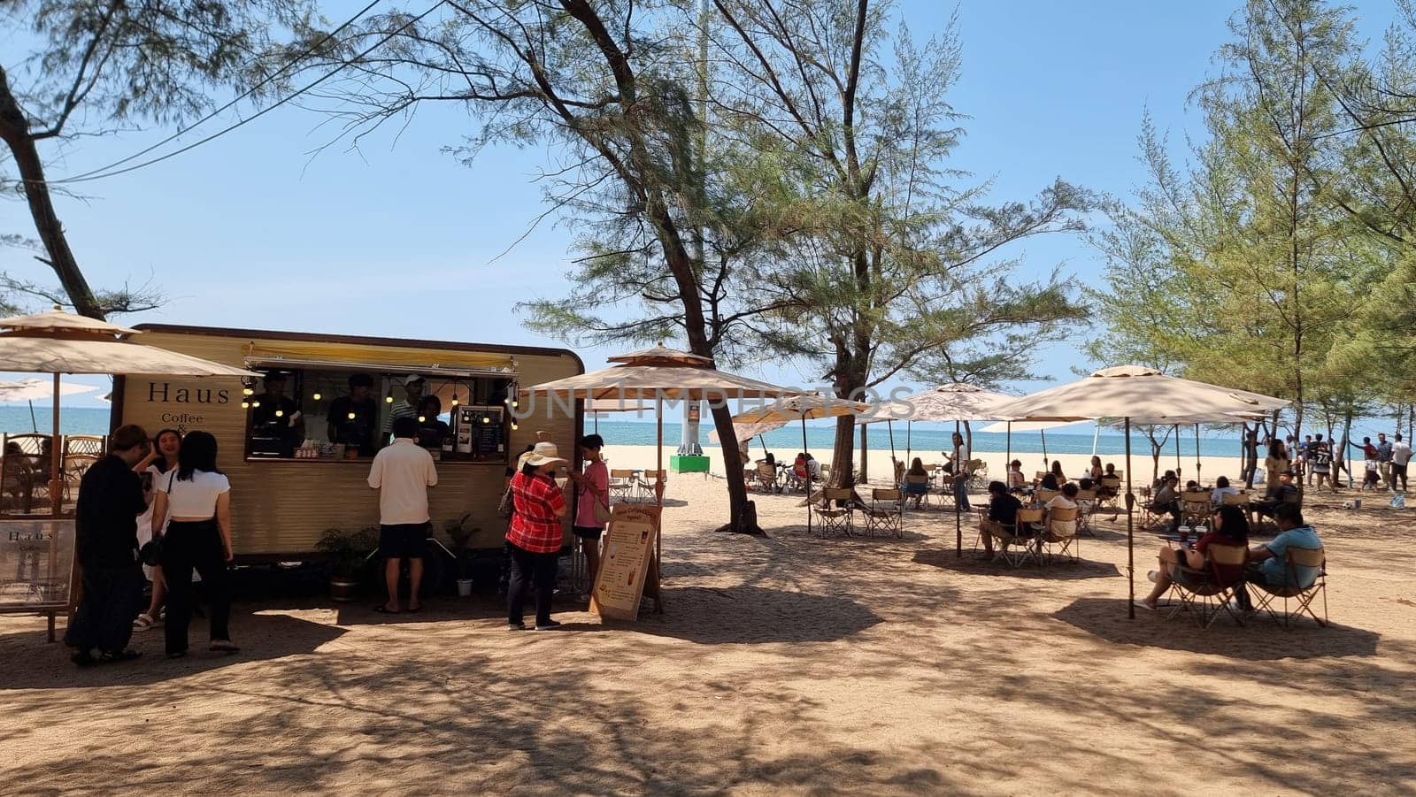 A diverse group of people, dressed in casual clothes, surrounded by a vibrant food truck, engaging in conversations, enjoying street food by fokkebok