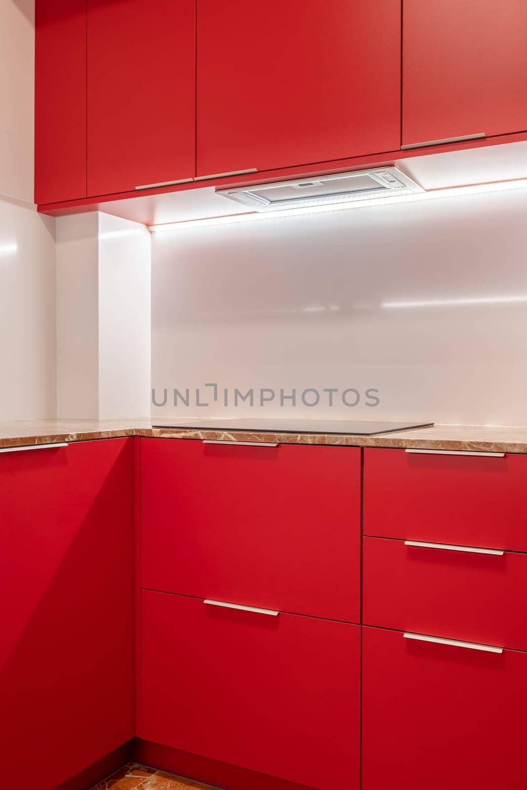 Minimalist kitchen corner with vibrant red cabinets and white walls by apavlin