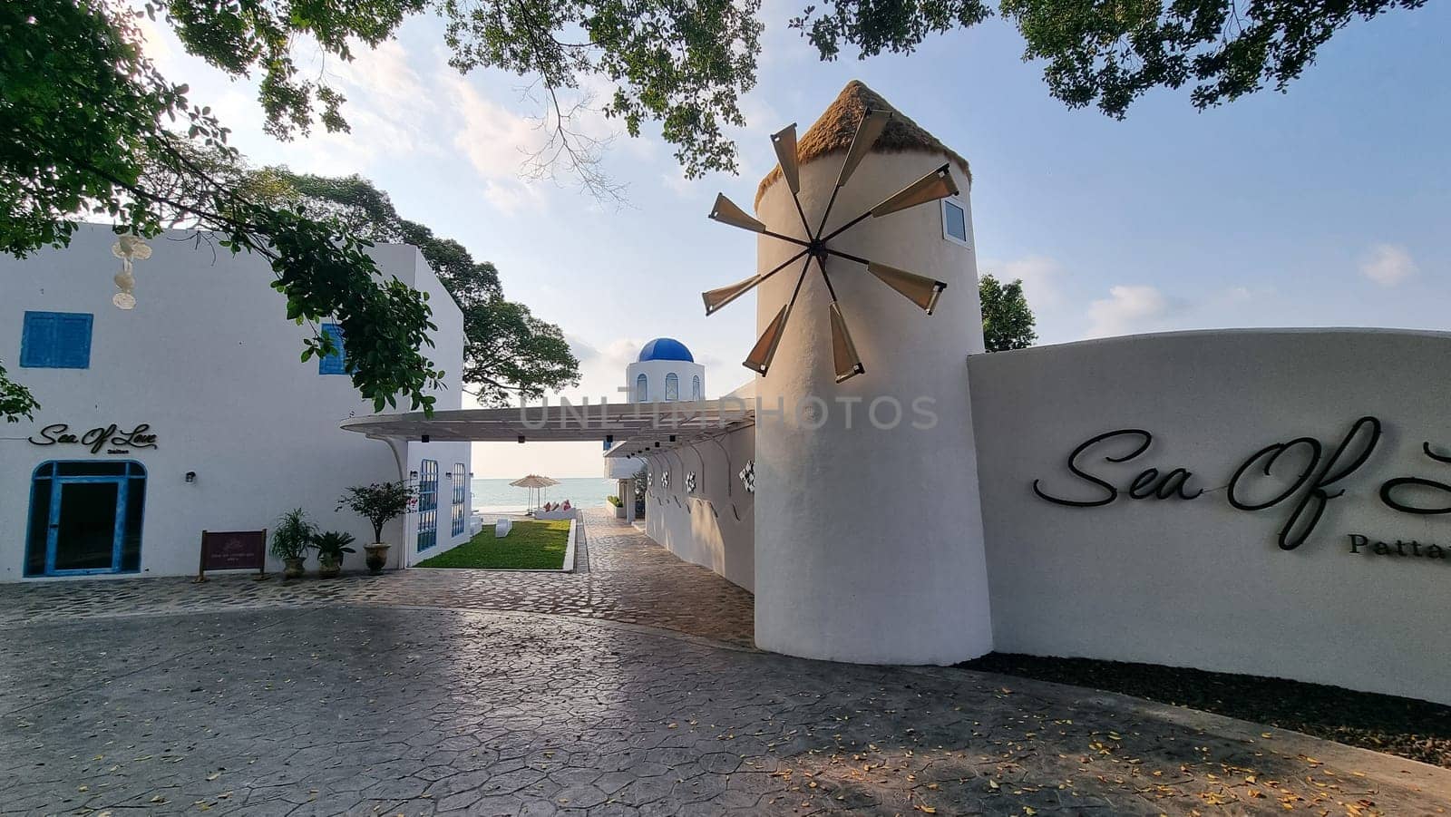 A majestic white building standing tall, adorned with a sign that reads Sea Off, inviting visitors to experience the wonders of the oceanfront by fokkebok