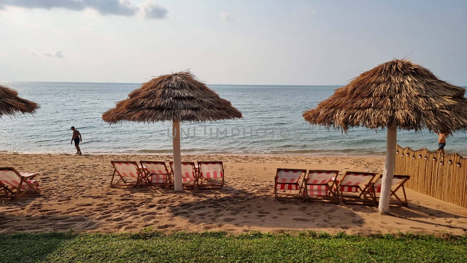 Bangsaray Pattaya Thailand 28 February 2024, Chairs and umbrellas adorn a tranquil beach near the ocean, inviting relaxation and enjoyment of the scenic coastal views.