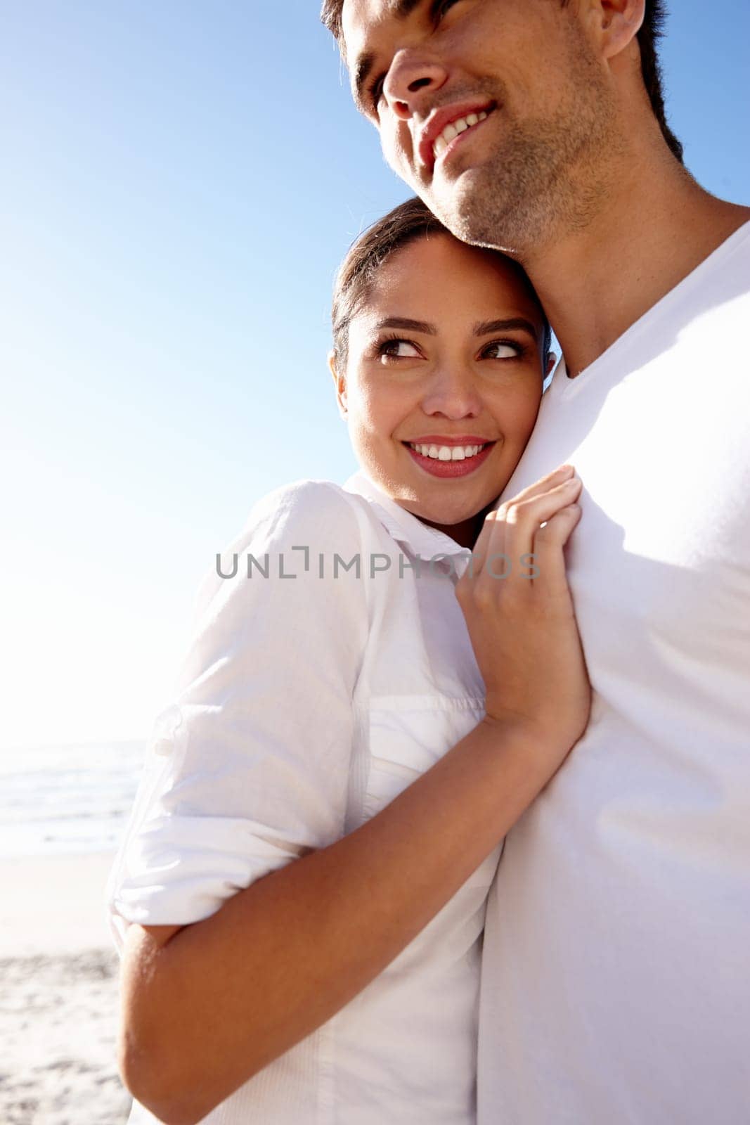 Happy, hug and couple on beach on holiday for bonding, relax together and relationship by ocean. Dating, travel and man and woman embrace for romance on anniversary, vacation and weekend in nature.