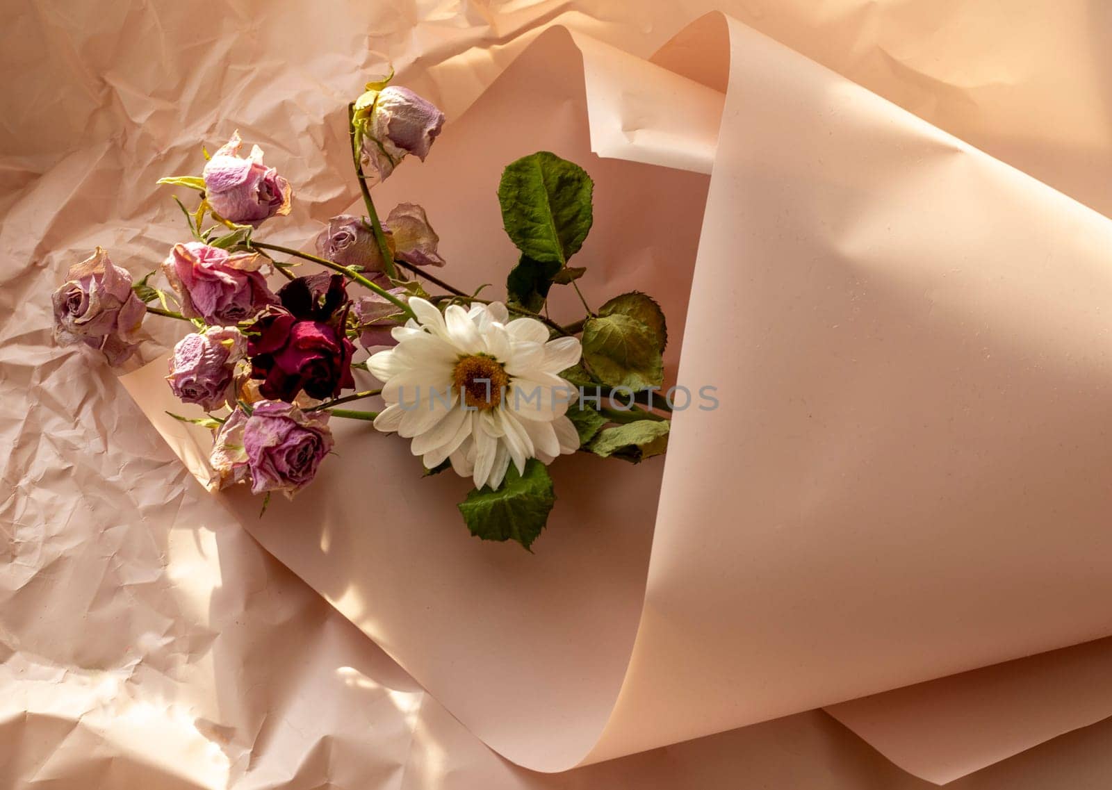 Concept shot of the background theme, wrapping paper, dried roses other flowers and other arrangements.