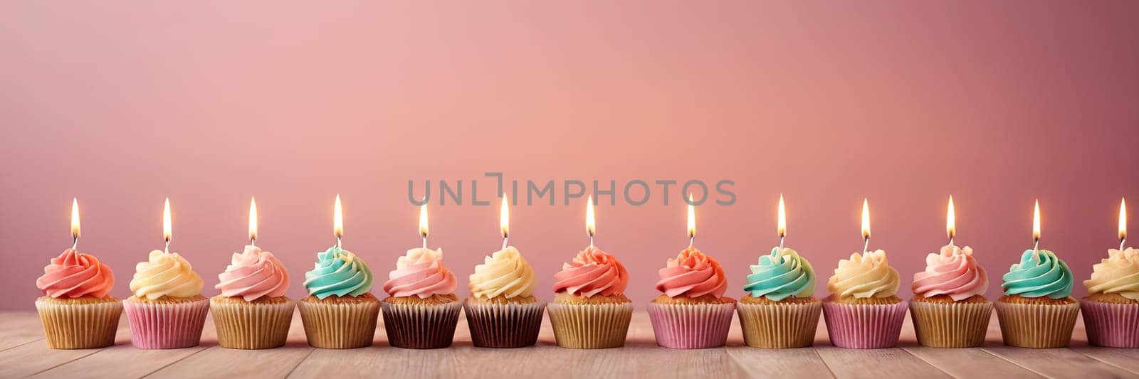 Colorful cupcakes with lit candles are displayed against a pink background, indicating an indoor celebration event marking of joy and celebrating. with free space.