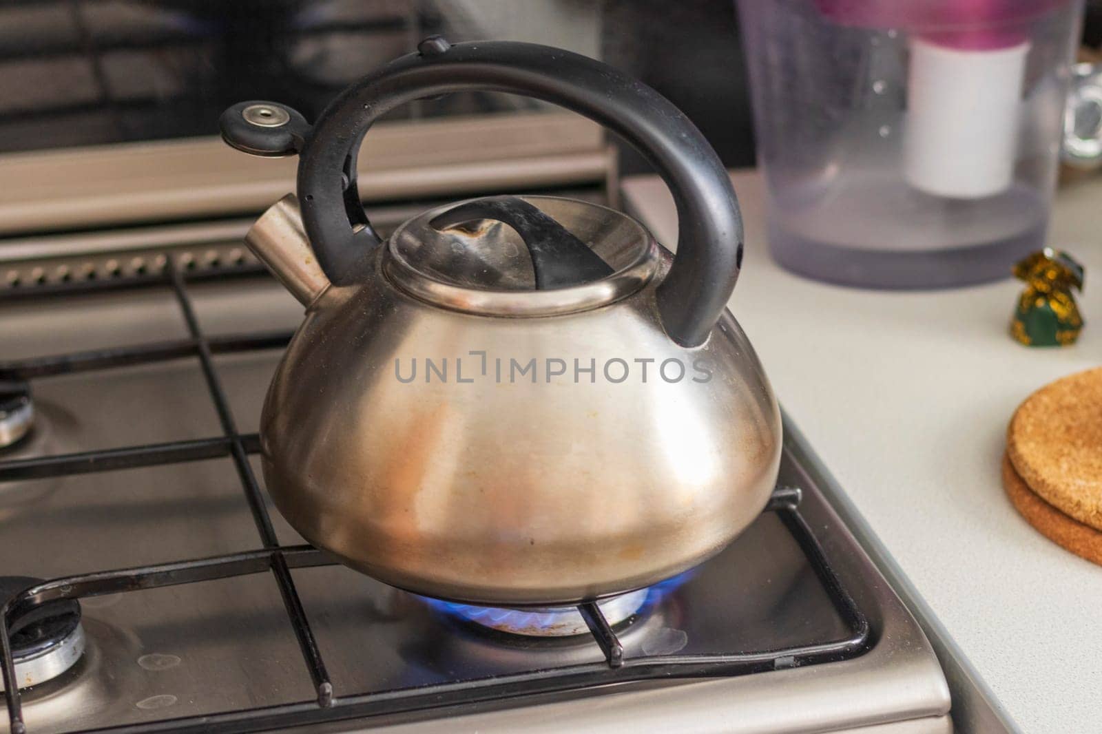 Close up shot of an old kettle on the gas stove