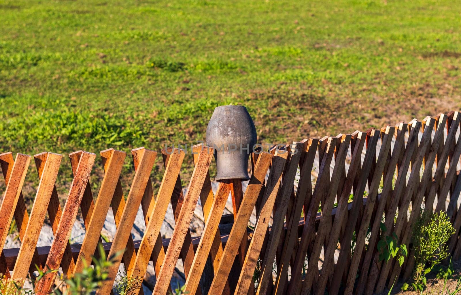 Close up shot of the clay jar on on the fence in the village
