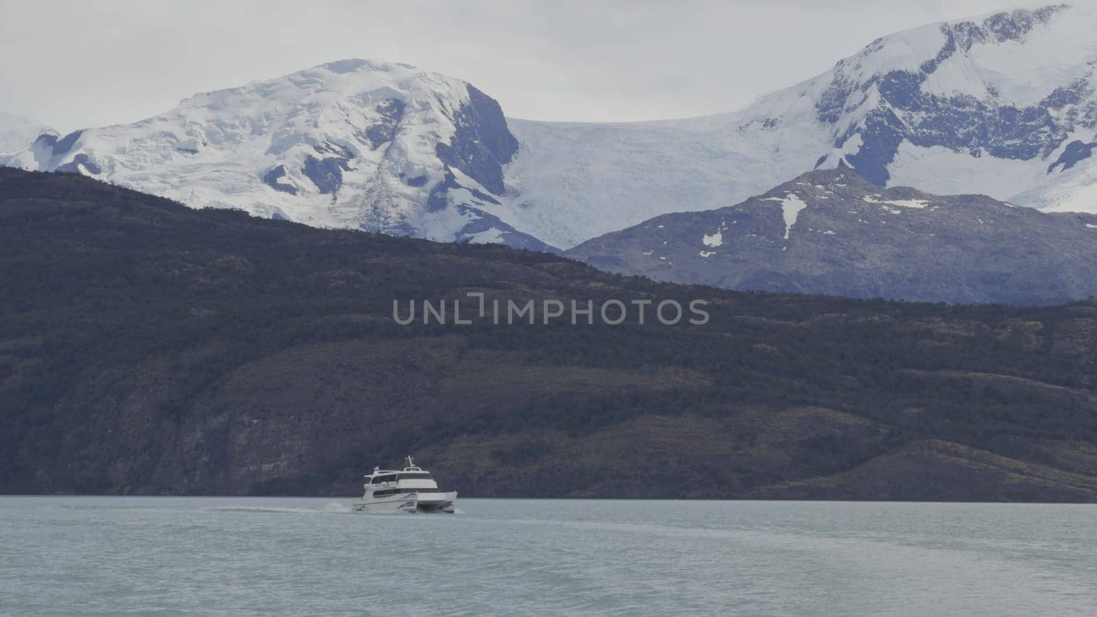 Glacier-Crowned Mountains and Boat on Serene Lake by FerradalFCG