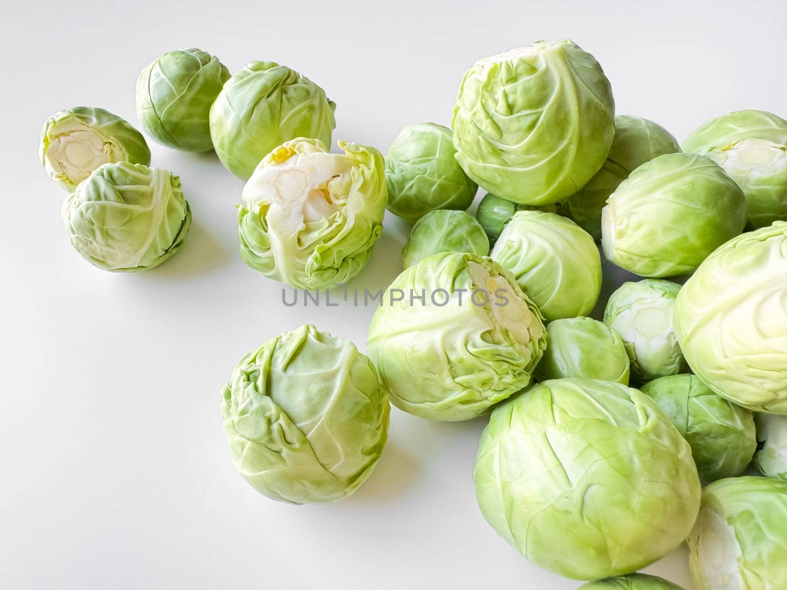 Fresh Brussels sprouts on white background, healthy green vegetable concept with copy space. High quality photo